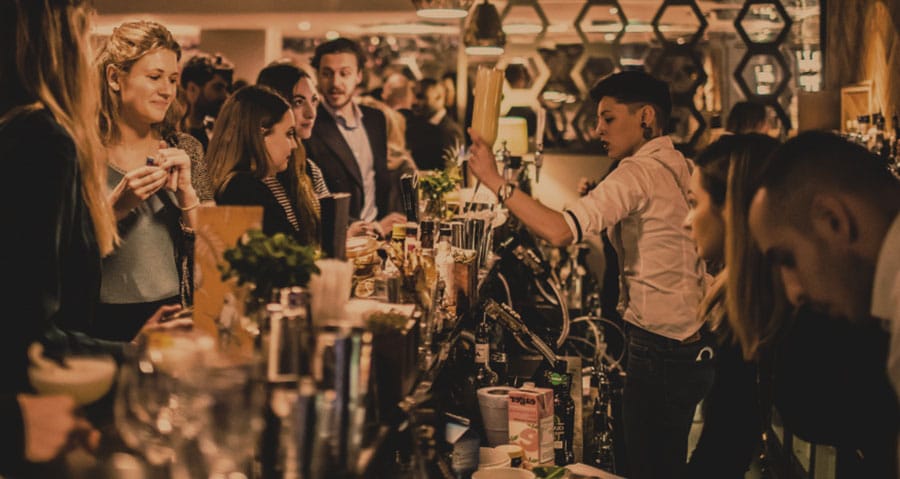 gloworder-image-of-several-girls-at-bar-awaiting-drinks-from-bartender